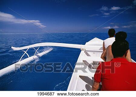 Stock Photo - French Polynesia, Tahiti, Outrigger In Coral Waters Of Bora Bora, People In Canoe. Fotosearch