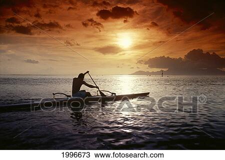 Stock Image - French Polynesia, Tahiti, Papeete, Native Man Kayaking In Warm Sunset A56E. Fotosearch