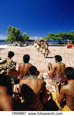 French Polynesia, Tahiti, Tahitian Dancers, Group Of Men Sit Watching Younger Boys Dancing View Large Photo Image Stock Photo - French Polynesia, Tahiti, Tahitian Dancers, Group Of Men Sit Watching Younger Boys Dancing. Fotosearch