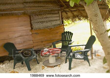 French Polynesia, Tahiti, Tuamotu, Plastic Chairs Around A Small Table Outside Of A Small Bed And Breakfast View Large Photo Image Stock Photo - French Polynesia, Tahiti, Tuamotu, Plastic Chairs Around A Small Table Outside Of A Small Bed And Breakfast. Fotosearch