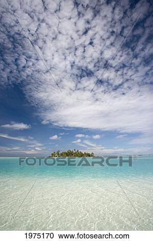 Stock Image - French Polynesia, Tuamotu Islands, Rangiora, Turquoise Water And Blue Skies Surround Isolated Isalnd.. Fotosearch