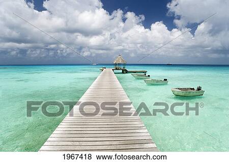 Stock Photo - French Polynesia, Tuamotu Islands, Rangiroa Atoll, Resort Pier And Boats.. Fotosearch