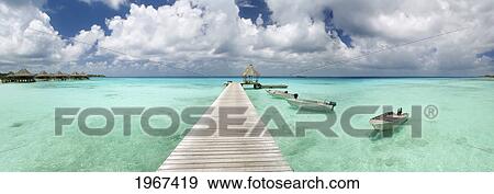 Stock Photo - French Polynesia, Tuamotu Islands, Rangiroa Atoll, Resort Pier And Boats.. Fotosearch