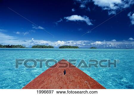 Stock Photo - French Polynesia, Tuamotu Islands, Small Motu Of Raiatea In Distance, Bow Of Boat, Shallow Ocean A57C. Fotosearch