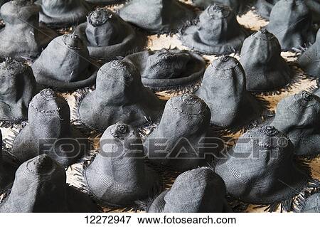Stock Photo - Freshly woven and dyed panama hats made from toquilla straw drying at the Homero Ortega Panama Hat Factory, Cuenca, Azuay, Ecuador. Fotosearch