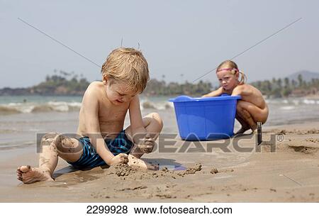 Stock Photo - Friends play on Patnum beach, Goa, India.. Fotosearch
