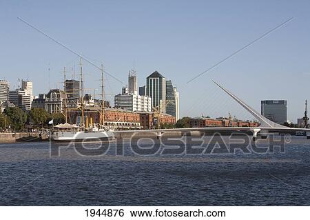 Stock Photograph - Frigate Presidente Sarmiento Boat-Museum and Santiago Calatrava's Puente de La Mujer (Women's Bridge) in Puerto Madero, Buenos Aires, Capital Federal, Argentina. Fotosearch