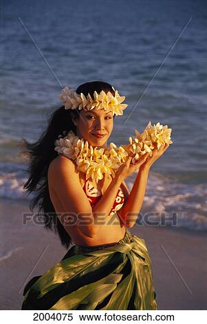 Stock Photography - Front Angle Of Woman On Beach Wearing Plumeria Haku, Holding Plumeria Lei, Ocean Background. Fotosearch