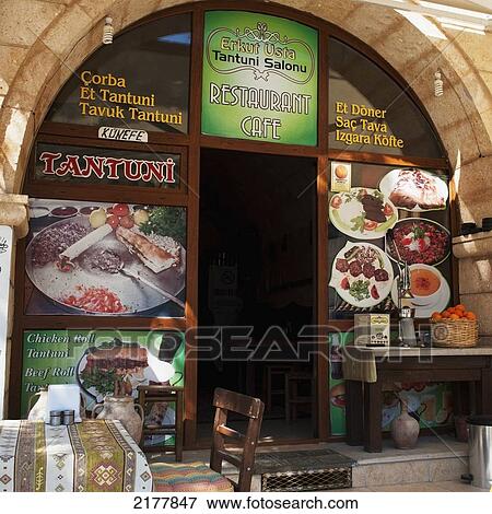 Front Of A Restaurant With Pictures Of Food Advertised Around The Door Frame; Mustafapasa Nevsehir Turkey View Large Photo Image Stock Photo - Front Of A Restaurant With Pictures Of Food Advertised Around The Door Frame; Mustafapasa Nevsehir Turkey. Fotosearch