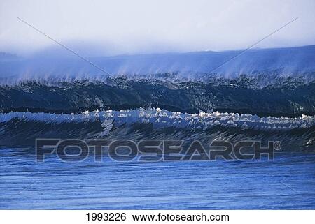 Stock Photograph - Front View Of Crystal Clear Wave With Little Spray Off Tips, Reflections In Center. Fotosearch