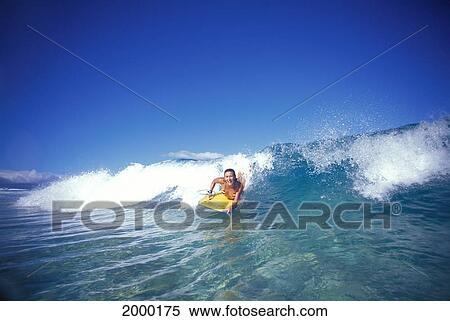 Stock Photography - Front View Woman Riding Shore Break Wave, Smiling Cloudless Blue Sky Body Boarder. Fotosearch