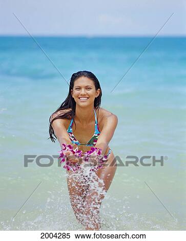 Front View Young Woman Stand In Ocean Shoreline Splash Water, Smiling Turquoise Background View Large Photo Image Stock Photography - Front View Young Woman Stand In Ocean Shoreline Splash Water, Smiling Turquoise Background. Fotosearch