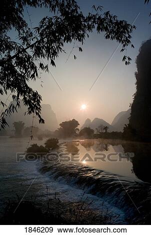 Stock Photo - Frozen Pond In Mountain Area; Yulong River, Yangshuo, China. Fotosearch