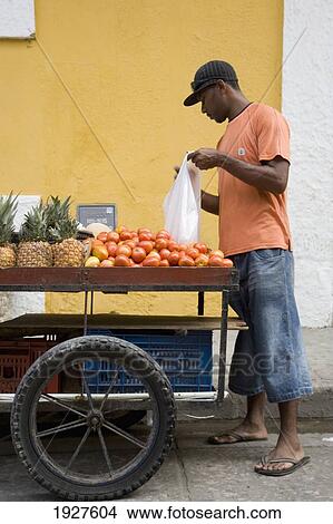 Picture - Fruit Seller In The Street. Fotosearch