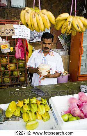 Fruit Stall Owner Serving Coconut Milk View Large Photo Image Stock Image - Fruit Stall Owner Serving Coconut Milk. Fotosearch