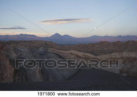Stock Image - Full Moon Over The Valle De La Luna In The Cordillera De La Sal At Sunset, San Pedro De Atacama, Antofagasta Region, Chile. Fotosearch
