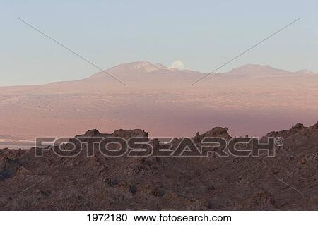 Stock Image - Full Moon Rising Over The Valle De La Luna (Moon Valley) At Sunset, San Pedro De Atacama, Antofagasta Region, Chile. Fotosearch