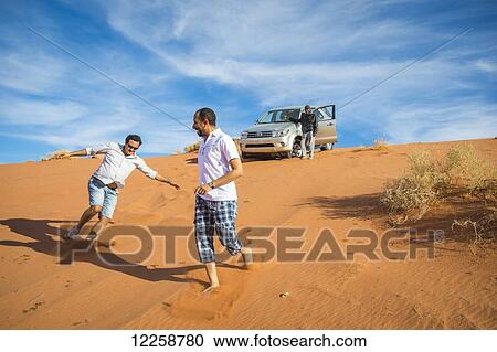 Stock Image - Fun in the sand dunes; Tabuk, Saudi Arabia. Fotosearch