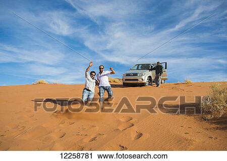 Stock Image - Fun in the sand dunes; Tabuk, Saudi Arabia. Fotosearch