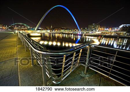 Stock Image - Futuristic Bridge At Night; Gateshead, Northumberland, England. Fotosearch