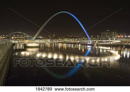 Stock Photo - Futuristic Illuminated Bridge At Night; Gateshead, Northumberland, England. Fotosearch