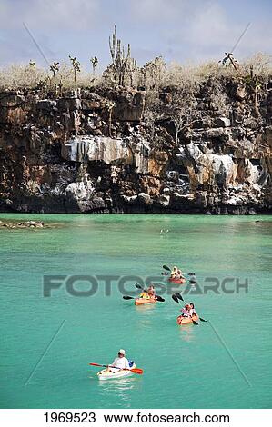 Stock Image - Galapagos, Santa Cruz Island, Kayakers Exploring The Waters Off Santa Cruz Island.. Fotosearch