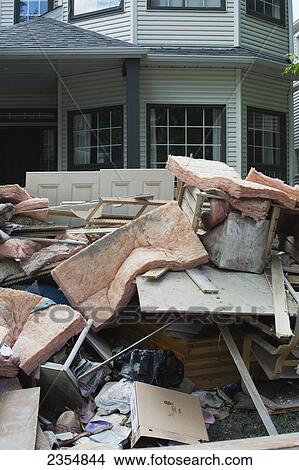 Picture - Garbage And Destroyed Household Items Piled Outside A Home After A Flood; Calgary, Alberta, Canada. Fotosearch