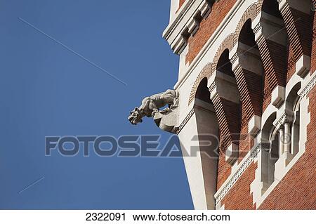 Gargoyle on edge of brick castle tower and blue sky; Milano, Lombardia, Italy View Large Photo Image Stock Image - Gargoyle on edge of brick castle tower and blue sky; Milano, Lombardia, Italy. Fotosearch