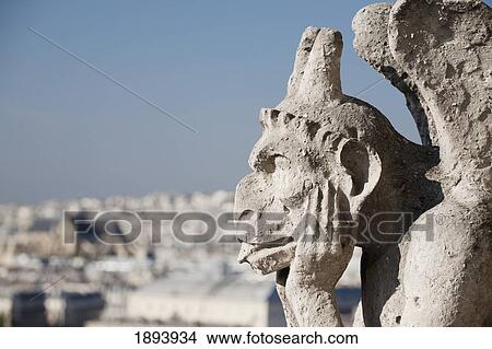 Picture - Gargoyle Overlooking Paris With It's Tongue Sticking Out; Paris, France. Fotosearch