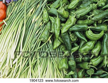 Stock Image - Garlic Shoots And Green Peppers For Sale At The Kashgar Sunday Market, Xinjiang, China.. Fotosearch
