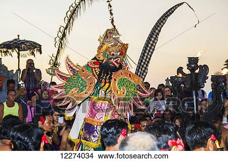 Garuda surrounded by men sitting in a circle chanting in trance during a Kecak dance performance, Ulu Watu, Bali, Indonesia View Large Photo Image Picture - Garuda surrounded by men sitting in a circle chanting in trance during a Kecak dance performance, Ulu Watu, Bali, Indonesia. Fotosearch
