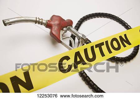 Stock Photograph - Gas pump and caution tape on white background. Fotosearch