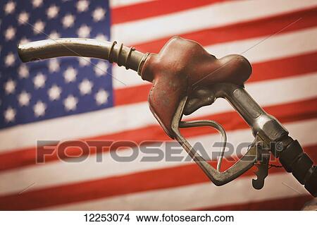 Picture - Gas pump and hose with American flag. Fotosearch