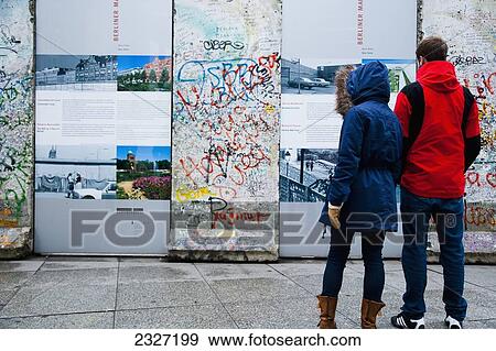Germany, Berlin, Iron Curtain; Potsdamer Platz, Tourists watching pieces of original Berlin Wall View Large Photo Image Stock Photo - Germany, Berlin, Iron Curtain; Potsdamer Platz, Tourists watching pieces of original Berlin Wall. Fotosearch