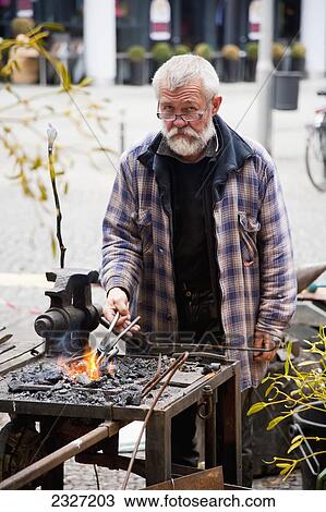 Stock Image - Germany, Berlin, Portrait of man at Christmas Market; Potsdamer Platz. Fotosearch