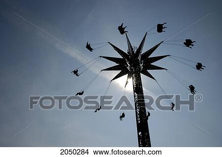 Giant Swings High In The Air Silhouetted By The Sun, Canadian National Exhibition, Toronto, Ontario View Large Photo Image Picture - Giant Swings High In The Air Silhouetted By The Sun, Canadian National Exhibition, Toronto, Ontario. Fotosearch