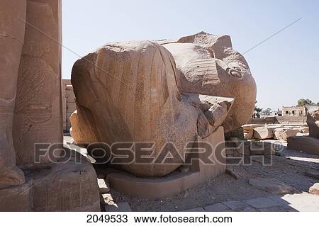 Stock Image - Gigantic Seated Colossus Of Ramses Ii, Once Approximately 20M High, Has Fallen To The Ground And Now Lies Face Down, In Fragments By The Temple Of Ramses Ii At The Ramesseum, Western Thebes, Qina, Egypt. Fotosearch