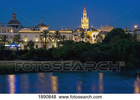 Giralda Illuminated At Dusk, Rio Guadalquivir View Large Photo Image Stock Photo - Giralda Illuminated At Dusk, Rio Guadalquivir. Fotosearch