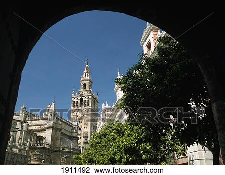 Stock Image - Giralda Tower Through Archway, Seville, Andalucia, Spain. Fotosearch
