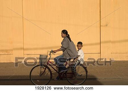 Stock Photograph - Girl And Boy On Bicycle. Fotosearch