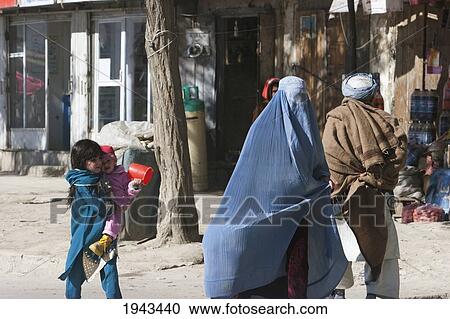 Girl And Child Follow Their Mother Wearing A Burqa On A Kabul Street,, Afghanistan View Large Photo Image Stock Image - Girl And Child Follow Their Mother Wearing A Burqa On A Kabul Street,, Afghanistan. Fotosearch