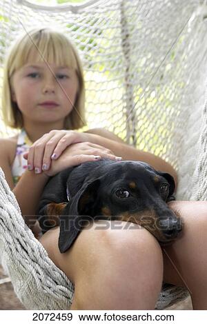 Stock Photo - Girl And Dog In Hammock. Fotosearch
