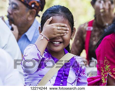 Picture - Girl at a Ngaben or Cremation Ceremony, Klungkung, Bali, Indonesia. Fotosearch