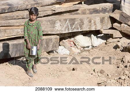 Stock Photo - Girl By A Home Destroyed By The 8 October 2005 Earthquake, As Seen From The Chikar To Saran Road, Azad Kashmir, Pakistan. Fotosearch