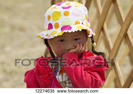 Stock Photography - Girl by a lattice wall-section of a Mongolian ger (yurt), Gobi Gurvansaikhan National Park,? mnÃƒÆ’Ã‚Â·govi Province, Mongolia. Fotosearch