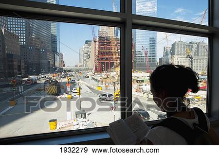 Stock Photo - Girl Checking A Map In Front Of The World Trade Center Building Site, Manhattan, New York, Usa. Fotosearch