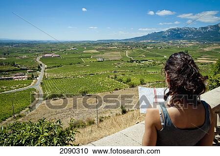 Stock Image - Girl Checking A Map In La Rioja Alavesa, Basque Country, Spain. Fotosearch