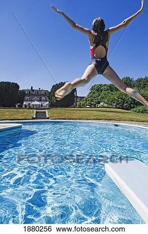 Stock Photograph - Girl Diving Into A Swimming Pool.. Fotosearch