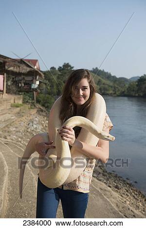 Girl holding a python; Thaton, Chiang Rai, Thailand View Large Photo Image Stock Image - Girl holding a python; Thaton, Chiang Rai, Thailand. Fotosearch