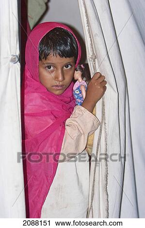 Stock Image - Girl In A Relief Camp Tent At Night After The 8 October 2005 Earthquake, Bagh, Azad Kashmir, Pakistan. Fotosearch